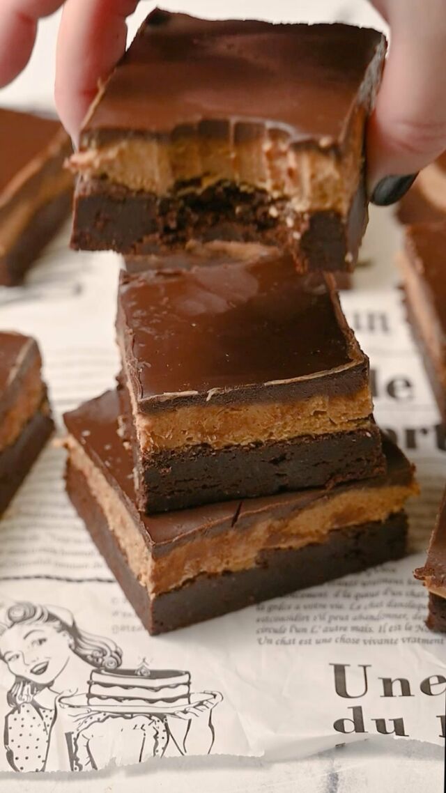These Buckeye Brownies are decadent and delicious with a chewy brownie base covered with a succulent peanut butter fudge layer and finished with creamy chocolate ganache.

Brownie Layer
-½ cup unsalted butter
-1 ¼ cup granulated sugar
-2 large eggs
-2 teaspoons vanilla extract
-6 tablespoons all-purpose flour( ¼ cup + 2 tablespoons)
-¾ cup unsweetened cocoa powder (I used dark)
-¼ teaspoon salt

Peanut Butter Layer
-¼ cup unsalted butter
-1 ¼ cup creamy peanut butter
-¾ cup powdered sugar

Ganache Layer
-1 cup dark chocolate chips
-¾ cup heavy whipping cream

Method
-Preheat oven to 350°F and line an 8 x 8-inch baking dish with parchment paper.
-Make the brownie layer by using a hand mixer on high to cream the softened butter with the sugar for 2-3 minutes.
-Add the eggs and vanilla and use the hand mixer on low until combined.
-Mix in flour, cocoa powder, and salt and transfer to your prepped baking dish, using a spatula to push the brownie batter to meet all four corners.
-Bake for 30-35 minutes, until a toothpick comes out clean. Allow to cool for at least 30 minutes before moving to the next step. 
-Make your peanut butter fudge layer by beating together softened butter, creamy peanut butter, and powdered sugar until smooth.
-Spread the peanut butter fudge mixture on top in an even layer.
-Make the ganache layer by adding the chocolate chips and heavy cream to a microwave-safe bowl. Microwave on high for 2 minutes. Use a whisk to combine until smooth.
-Pour the ganache over the peanut butter layer and use a spatula to spread it across in an even layer. Place in the refrigerator to cool and set for at least 2 hours before slicing and serving. #chocolatepeanutbutter #buckeyebrownies #brownierecipe