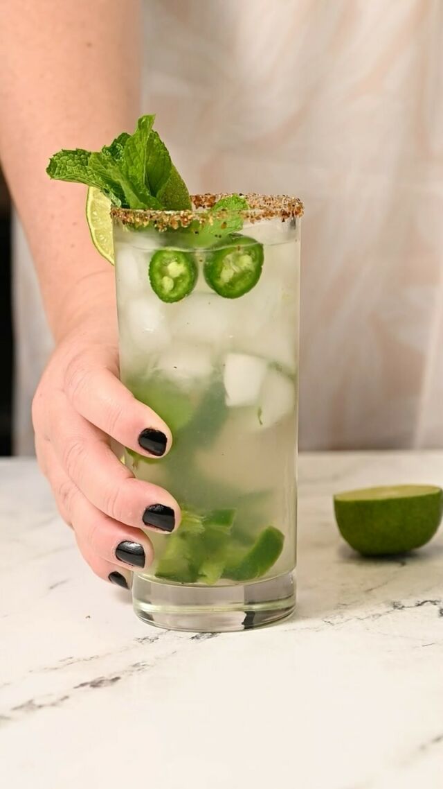 This Spicy Mojito uses a combination of jalapeño, mint, and lime to bring you a flavorful and refreshing rum drink that is worth cheers-ing to!

-1 tablespoon Tajin (optional for rim)
-2 slices jalapeño (+ extra for garnish)
-1 sprig fresh spearmint (+ extra for garnish)
-1 ounce lime juice 
-1 ounce simple syrup (or 1 tablespoon granulated sugar)
-2 ounces white rum
-2 ounces club soda

-Optional Tajin rim: wet the rim of a highball glass by running a wet finger or lime wedge around the rim. Then, add Tajin to a shallow bowl or cocktail rimmer and dip the wet rim in, rotating until rim is coated.
-To a highball glass, add mint, jalapeño, and lime juice. Use a wooden spoon or muddler to crush the jalapeños and express the oils from the mint. **If you are using granulated sugar instead of simple syrup, add the sugar now and muddle it with the jalapeño, mint, and lime juice.** -Add the simple syrup and rum and stir to combine. -Fill your glass with ice and pour club soda on top. -Garnish with jalapeño spheres, lime wedge, and extra mint. Enjoy cold.