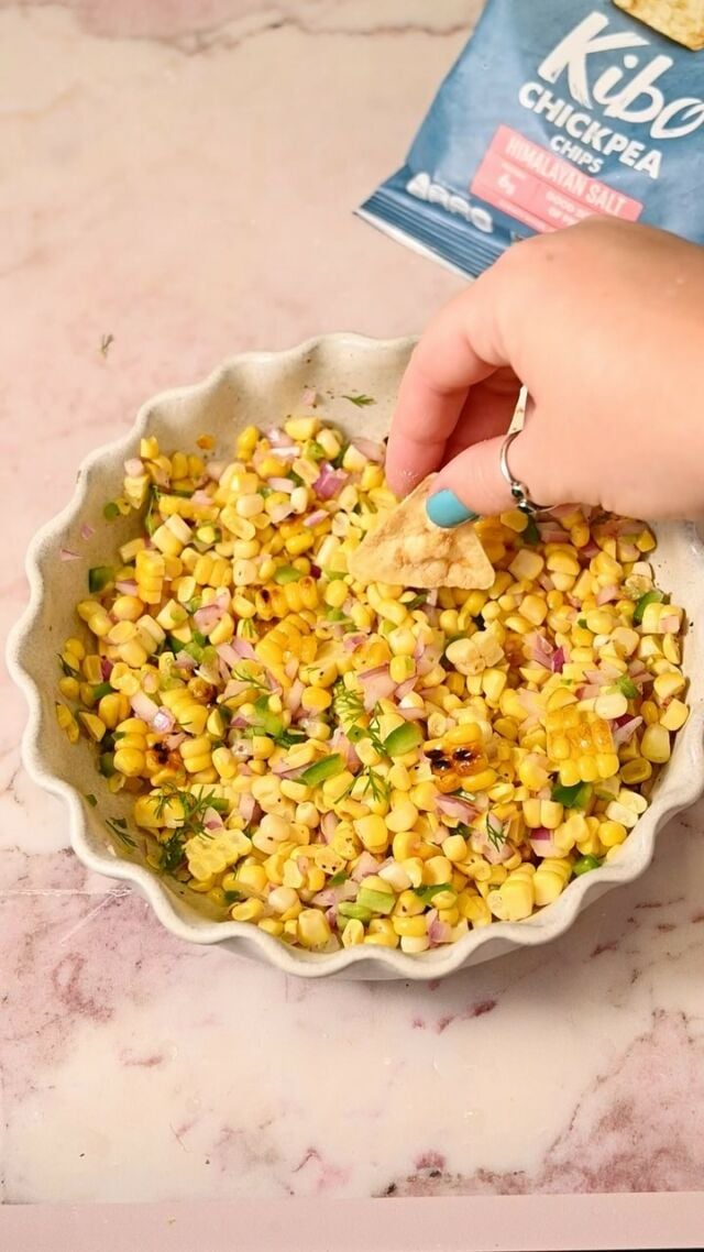#SayYumToNutritious with me this summer with my favorite @kibofoods chickpea chips paired with this Grilled Corn Salsa. Kibo chickpea chips are GMO-free, gluten-free,dairy-free, plant based, a good source of plant-based protein and fiber, and the perfect snack to scoop up this flavorful dip with their distinct crunch. Grab the full recipe for Grilled Corn Salsa below:
-4 ears corn
-1 jalapeno
-2 tablespoons olive oil
-½ large red onion
-2 tablespoons fresh cilantro
-2 tablespoons lime juice
- ½ teaspoon Tajin
-Kibo chips for serving

Method:
-Shuck your corn and add a thin layer of olive oil. Heat it directly on the grill for about 10 minutes, rotating every few minutes, until you have grill marks on all sides. Do the same for your jalapeno.
-Allow the corn to cool until it’s safe to handle. Then, slice the kernels off. Slice the jalapeno, remove the seeds, and then dice. Dice your red onion and chop the cilantro. 
-To a mixing bowl, add the corn, jalapeno, and onion. Add the lime juice, Tajin, and cilantro, and toss to combine. Enjoy warm or cold within 5 days with @kibofoods chickpea or lentil chips!