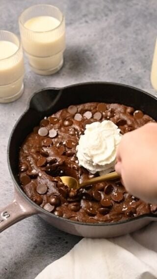 If you want the ultimate fudgy brownie to eat with a spoon, this decadent skillet brownie is for you! Easy to make, ready in under 30 minutes, and flecked with melty dark chocolate chips in every bite. 

Simple Skillet Brownie

- ½ cup unsalted butter (1 stick)
- 1 tablespoon oil (like vegetable or coconut)
- 1 ¼ cup granulated sugar
- 2 large eggs
- 2 teaspoons vanilla extract
- ½ cup all-purpose flour
- ½ cup cocoa powder (I used dark)
- ½ teaspoon salt
- 2 teaspoons espresso powder (optional)
- ¾ cup dark chocolate chips 
- Flaky sea salt and whipped cream to finish (optional)
Method
- Preheat the oven to 350°F.
- In an 8.5-inch cast iron skillet over medium heat, melt the butter. Option to leave the butter longer to brown it.
- Pour the melted butter into a large mixing bowl, leaving a thin coat of butter in the cast iron skillet.
- Add the oil and sugar to the melted butter and whisk to combine.
- Whisk in the eggs and vanilla extract.
- Whisk in the flour, cocoa powder, salt, and espresso powder (optional).
- Transfer the brownie batter back to the greased cast iron skillet and smooth it out in an even layer.
- Cover the batter with chocolate chips and bake for 20-22 minutes.
- Add the sea salt and whipped cream and enjoy!